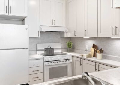 Bright modern cabinetry and white appliances.